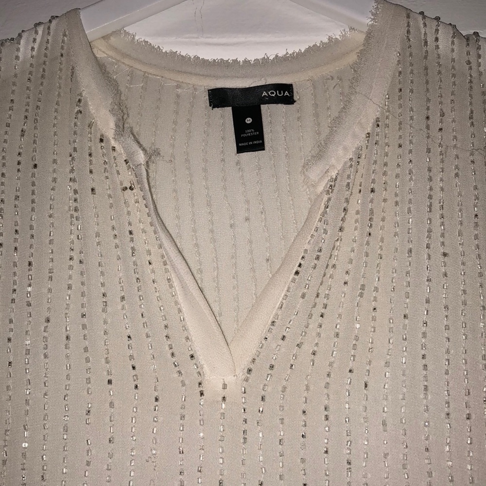 White beaded sleeveless blouse
